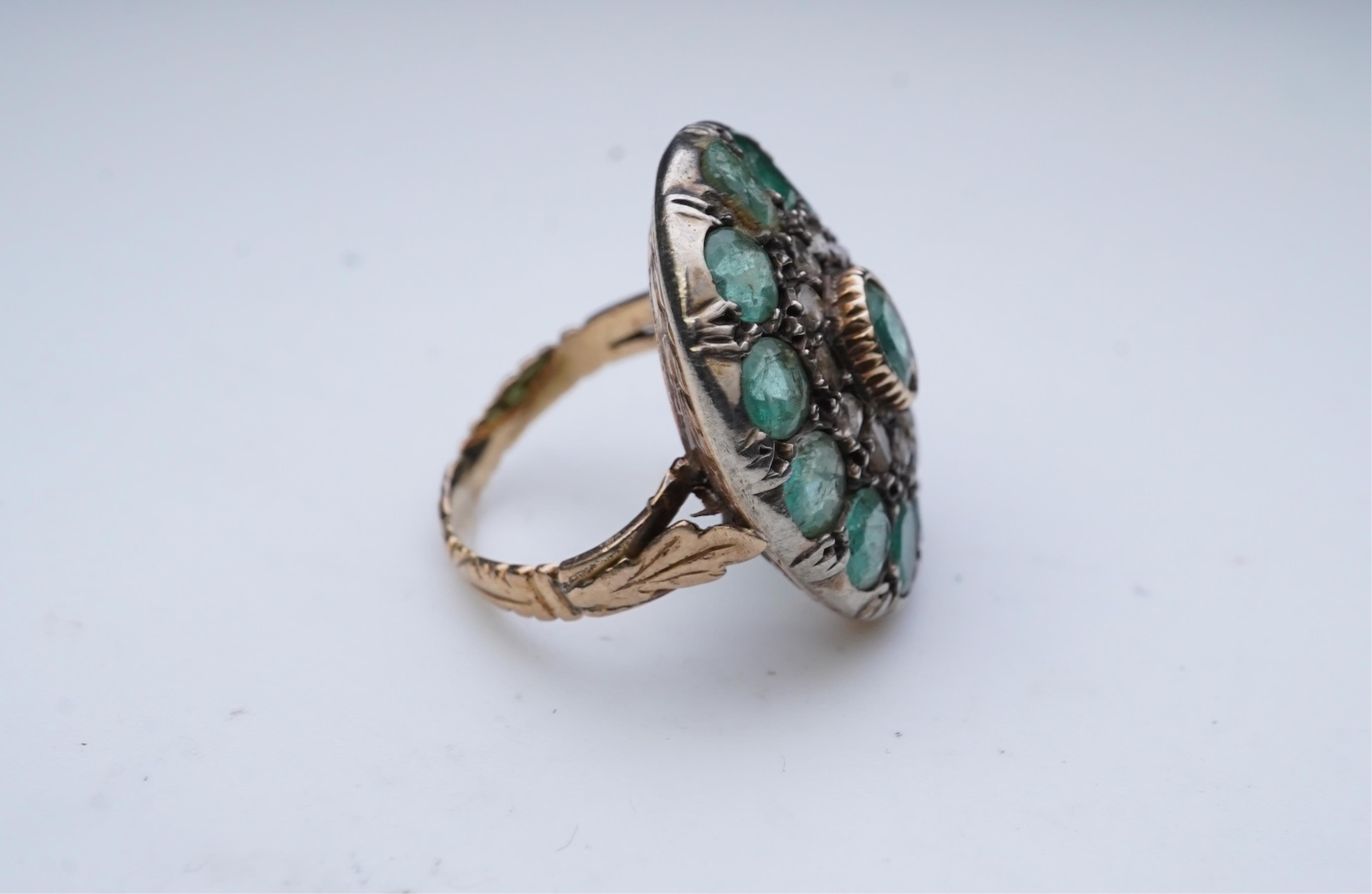 An emerald and diamond ring